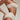 Woman wearing a beige strapless top and high-waisted bikini bottom  who had Bio curve Protocol done by Dr Cris 