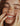 Close-up of a woman with freckles smiling with her eyes closed who had a lip flip botox in NYC