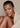 Woman wrapped in a towel against a beige background