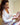 Woman in a white coat drawing patient face  in a clinical setting.